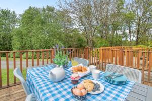 a blue and white table with food on a deck at 3 Bed in Tenby oc-93359 in Redberth