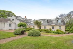 a large house with a yard with bushes at 3 Bed in Tenby oc-93359 in Redberth