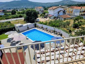 a view of a pool from a balcony of a villa at Apartman Quattro 2 in Međugorje