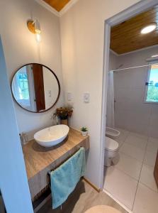 a bathroom with a sink and a mirror and a toilet at Casa de campo ElChale cerca del autodromo de Rafaela in Rafaela
