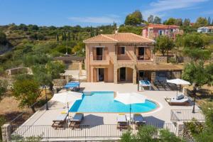 an image of a villa with a swimming pool at Villa Sandy Cove by Villa Plus in Spartià
