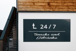 a sign on the side of a building with stairs at Schreinerfeld-Appartements in Ergolding
