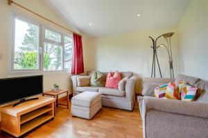 a living room with two couches and a flat screen tv at 2 Bed in St. Merryn oc-p00883 in Saint Merryn