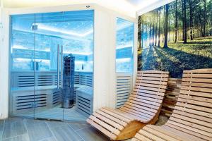 two wooden chairs sitting on a porch with a window at Hotel am Katharinenholz in Potsdam +119 photos