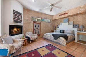 a bedroom with a bed and a fireplace at The Bubbling Wells Oasis, 3 Homes on 107 Acres in Desert Hot Springs