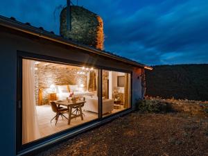 a glass extension of a house with a living room at Burg Coraidelstein in Klotten
