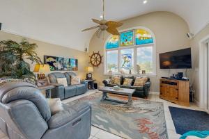 a living room with couches and a tv at CJ314FLR The Mermaid Manor in Cudjoe Key