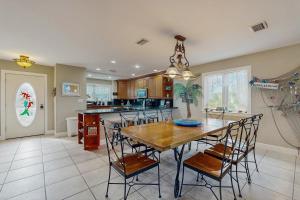 a large kitchen with a wooden table and chairs at CJ314FLR The Mermaid Manor in Cudjoe Key