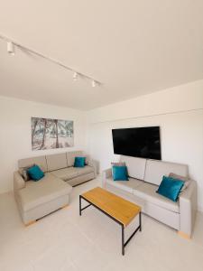 a living room with two couches and a flat screen tv at Concorde Luxury Ocean View in Portimão
