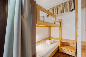 a small room with two bunk beds and a curtain at Serenity Troia, By Home Match in Troia