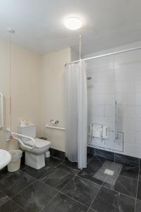 a bathroom with a toilet and a shower and a sink at The Bannville Hotel in Banbridge +23 photos