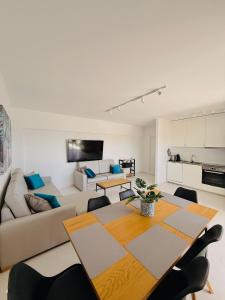 a living room with a table and a couch at Concorde Luxury Ocean View in Portimão +27 photos