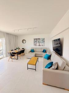 a living room with a couch and a table at Concorde Luxury Ocean View in Portimão