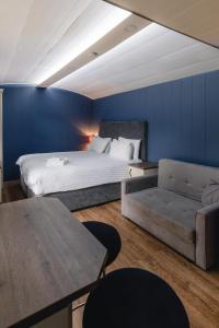a bedroom with a king sized bed and a couch at The Bannville Hotel in Banbridge