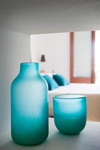 a blue vase sitting on top of a table at CBbC Suites Port Vell in Ibiza Town