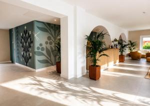 a living room with plants on the walls at Hotel Giardino La Playa - Adults Only in Alghero +66 photos
