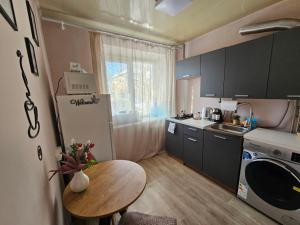 a small kitchen with a wooden table and a tableablish at Апартаменти Aura Bliss in Zhytomyr