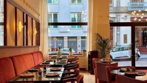 a restaurant with tables and chairs and a view of a street at Casa Falcão Boutique Hotel by Aspasios in Porto