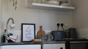 a kitchen with a counter top with a sign on it at The Bannville Hotel in Banbridge