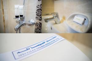 a bathroom with a sign on the side of a toilet at 325 · 2BR Townhouse 2 Bath TV in Sheikh Zayed +54 photos