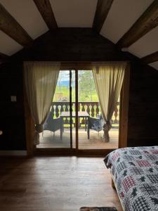a bedroom with a bed and a large glass door at Nakiska Bear Ranch in Clearwater
