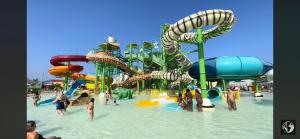 a water park with a water slide in the water at Luxury Home in Spata