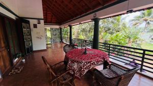 a table on the balcony of a house at Harbour villa 1 in Trivandrum