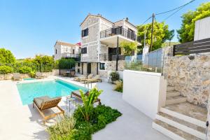 a home with a swimming pool and a house at Villa Metochi in Skala