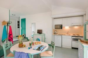 a kitchen and dining room with a table and chairs at LE SOUFFLE VERT in Cussac