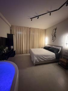a bedroom with a bed and a large window at Marilux oasi di relax in Marina di Carrara