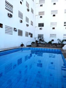 a swimming pool in front of a building at Hotel Armele Asunción in Asunción