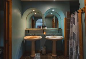 two sinks in a bathroom with two mirrors at Point Au Roche Lodge in Plattsburgh