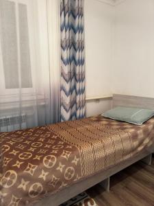 a bed sitting in a room with a window at East guest house in Tegermenti