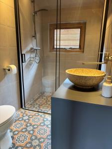 a bathroom with a counter with a sink and a shower at Tinkerbell in Oosterbeek