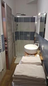 a bathroom with a sink and a shower at Il Flat Arona Centro, Le Dimore del Corso in Arona
