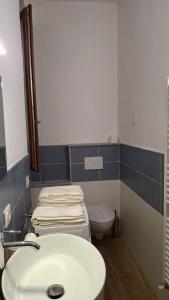 a bathroom with a white sink and a toilet at Il Flat Arona Centro, Le Dimore del Corso in Arona