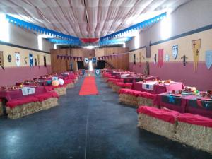 a large banquet hall with red tables and chairs at Quinta del Quinoto in Pajares de Adaja +113 photos
