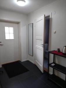 an empty room with a door and a mirror at Easystar guest house in Ingarö