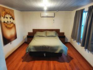 a bedroom with a bed and a painting on the wall at Serena in Maldonado