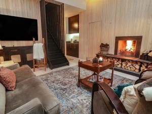 a living room with a couch and a fireplace at Hanowen House in Dungloe