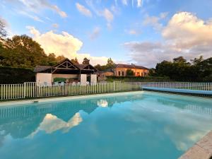 a swimming pool with a fence and blue water at Château de Craon in Craon