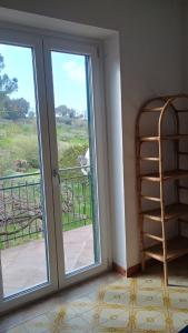 a room with a sliding glass door with a view at Domus amica 1 in Finocchito +3 photos