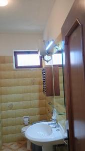 a bathroom with a sink and a toilet and a window at Domus amica 1 in Finocchito