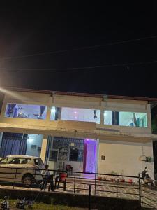 a police car parked in front of a building at night at Hotel glass house in Kāta Patthar