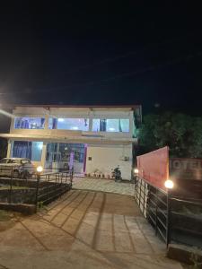 a building with a motorcycle parked in front of it at Hotel glass house in Kāta Patthar