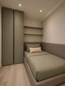 a small bedroom with two beds and shelves at Lake View Apartament 10 - Free Parking & Terrace in Cadegliano Viconago +7 photos