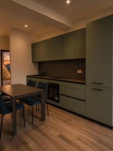 a kitchen with a table and chairs in a room at Lake View Apartament 10 - Free Parking & Terrace in Cadegliano Viconago