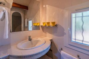 a white bathroom with a sink and a window at villa Léonfine in Le Cannet-des-Maures +24 photos