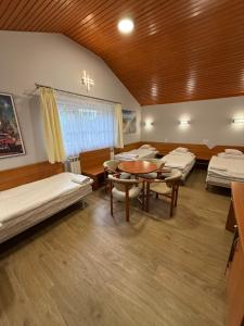 a room with several beds and a table in it at Motel Comet in Przeźmierowo +34 photos