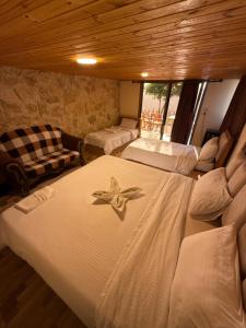 a bedroom with two beds with a flower on it at Dana panorama-green camp in Dana